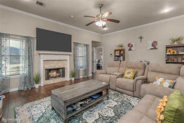 a living room with furniture a flat screen tv and a fireplace