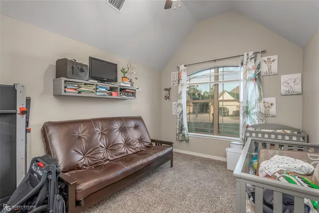a living room with furniture a flat screen tv and a window