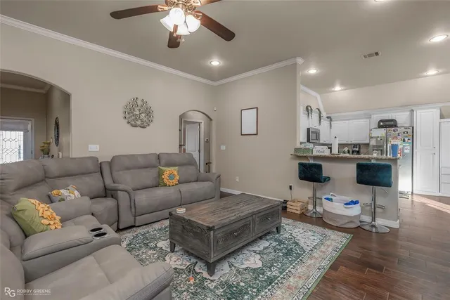 a living room with furniture and a chandelier