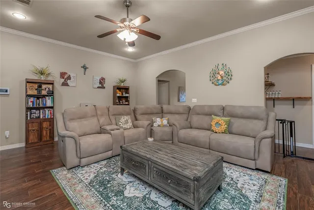 a living room with furniture a rug and a chandelier