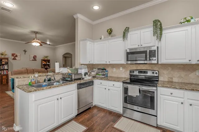 a kitchen with a sink stove and microwave