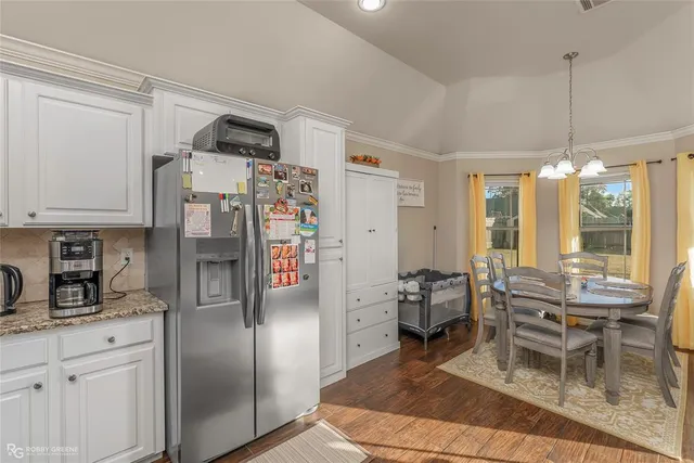 a kitchen with stainless steel appliances a refrigerator and wooden cabinets