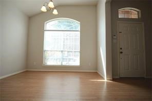 25202 Diamond Ranch Drive Katy, TX 77494 - Photo 7 of 13 an empty room with wooden floor cabinet and windows
