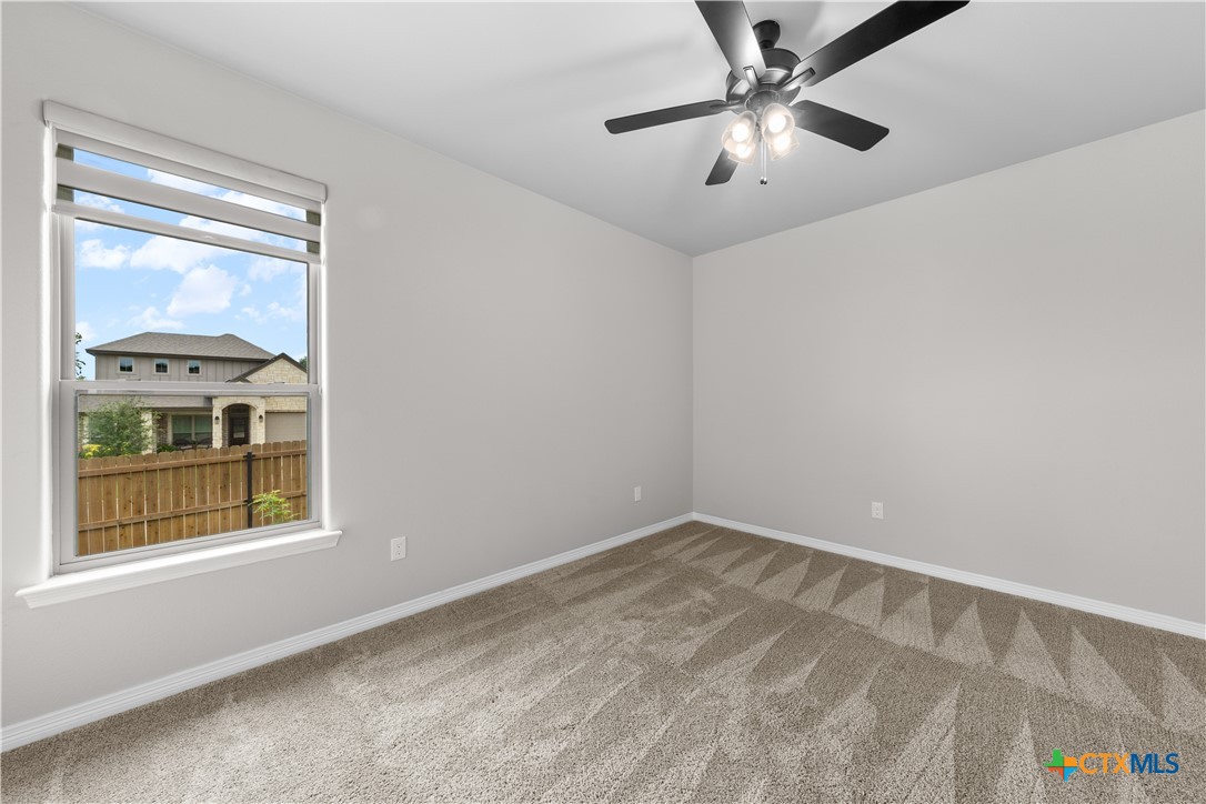 3405 Waggoner Drive Belton, TX 76513 - Photo 14 of 48 a view of an empty room with window and a ceiling fan