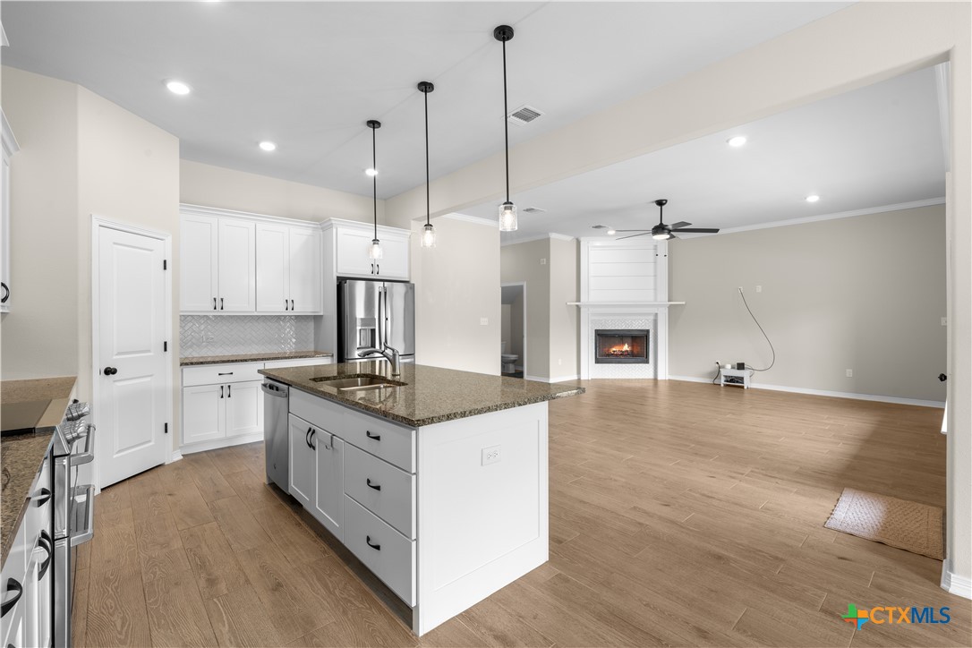 3405 Waggoner Drive Belton, TX 76513 - Photo 22 of 48 a kitchen with stainless steel appliances granite countertop a sink a stove and a wooden floors