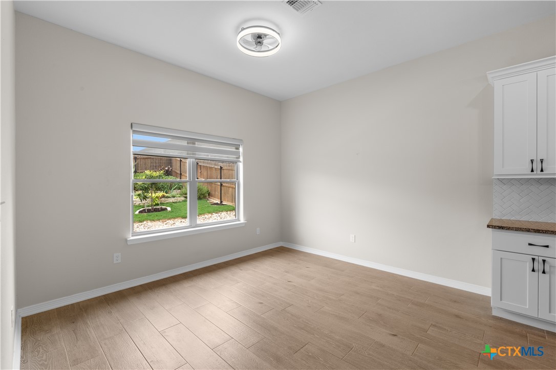 3405 Waggoner Drive Belton, TX 76513 - Photo 23 of 48 an empty room with wooden floor and windows