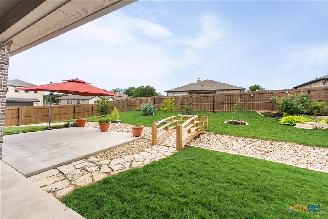 3405 Waggoner Drive Belton, TX 76513 - Photo 40 of 48 a view of a garden with a bench in front of the house