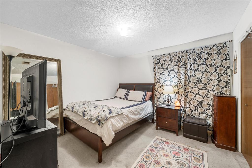 300 Travis Lane Hewitt, TX 76643 - Photo 12 of 18 a bedroom with a bed and a chair