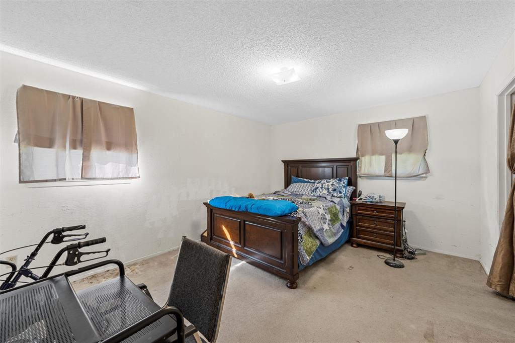 300 Travis Lane Hewitt, TX 76643 - Photo 16 of 18 a bedroom with a bed window and chair