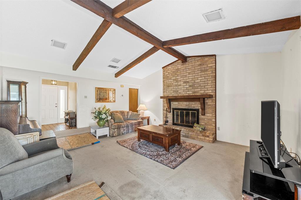 300 Travis Lane Hewitt, TX 76643 - Photo 9 of 18 a living room with furniture a fireplace and a flat screen tv