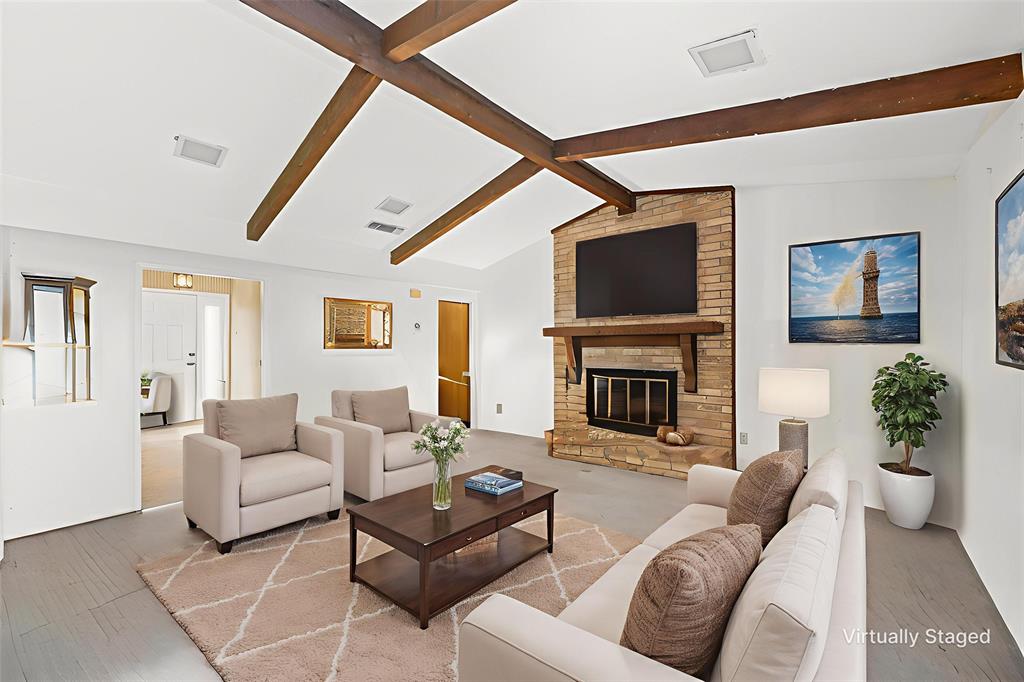 300 Travis Lane Hewitt, TX 76643 - Photo 10 of 18 a living room with furniture a fireplace and a flat screen tv