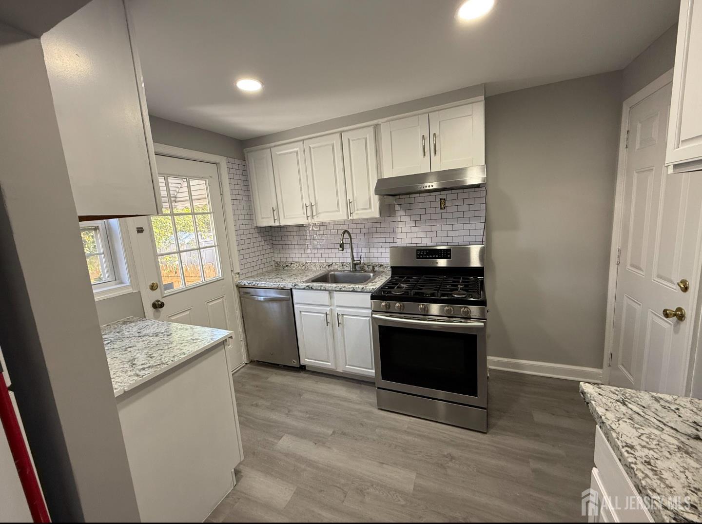 42 MacArthur Drive Edison, NJ 08837 - Photo 5 of 10 a kitchen with a sink stove and refrigerator