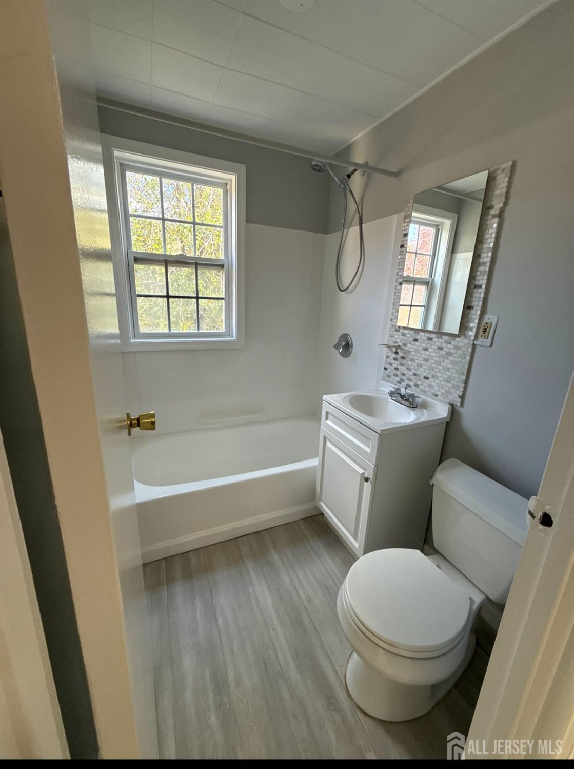 42 MacArthur Drive Edison, NJ 08837 - Photo 8 of 10 a bathroom with a sink a toilet and a bathtub