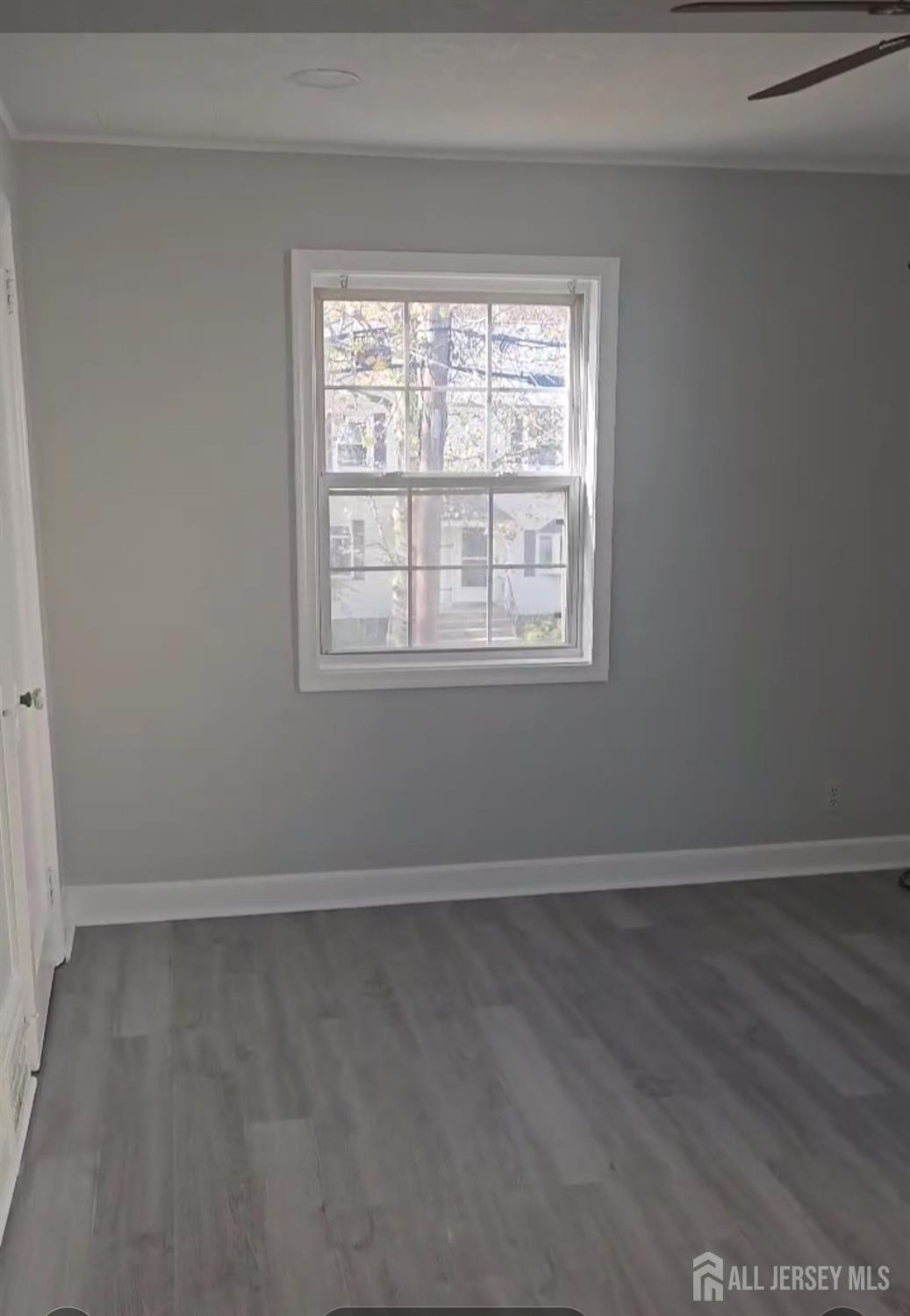 42 MacArthur Drive Edison, NJ 08837 - Photo 9 of 10 an empty room with wooden floor and windows