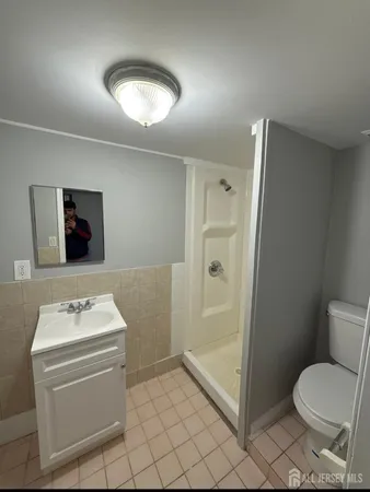 a bathroom with a toilet sink and shower