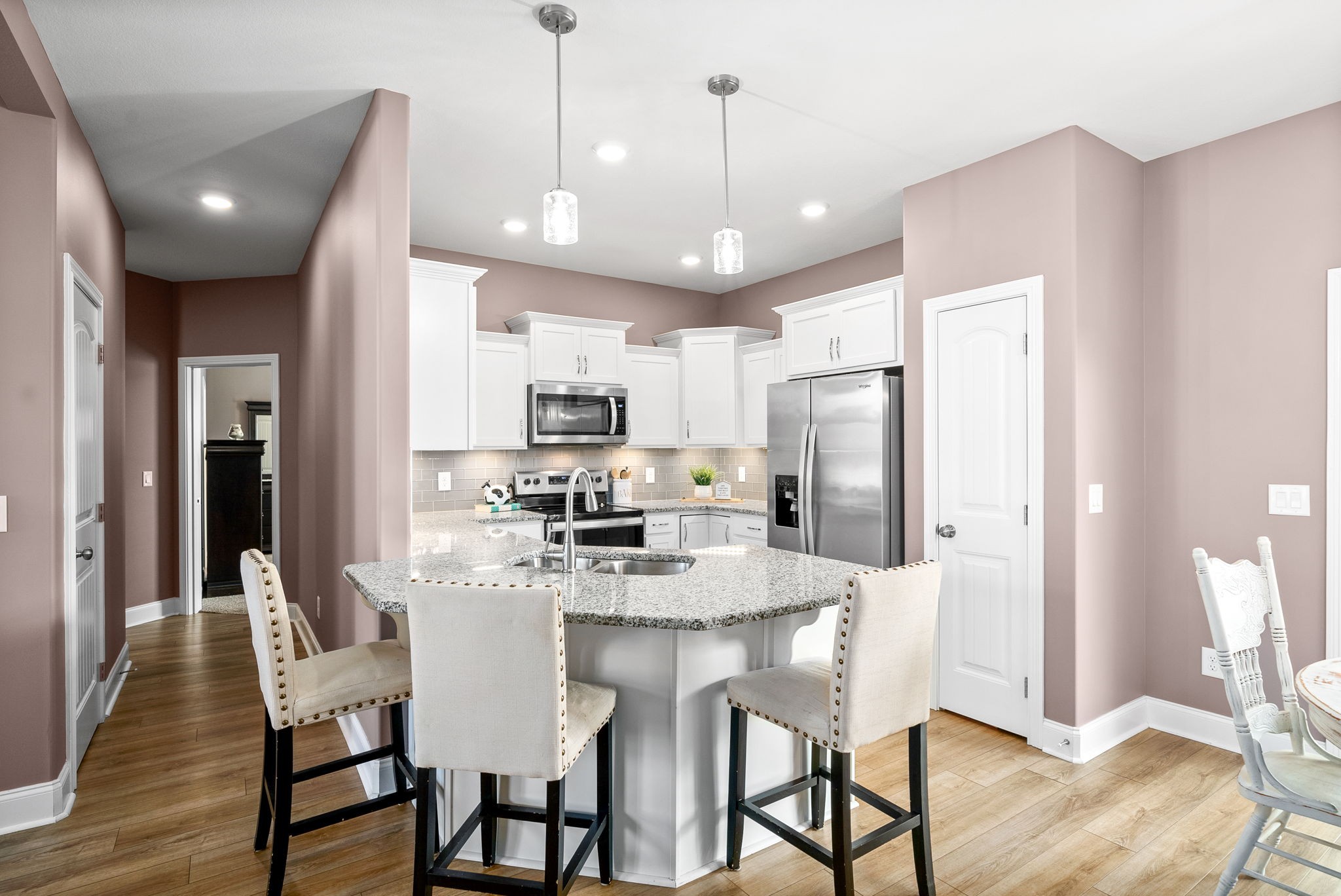 2251 Allen-Griffey Road Clarksville, TN 37042 - Photo 11 of 31 a kitchen with stainless steel appliances granite countertop a dining table chairs refrigerator and microwave