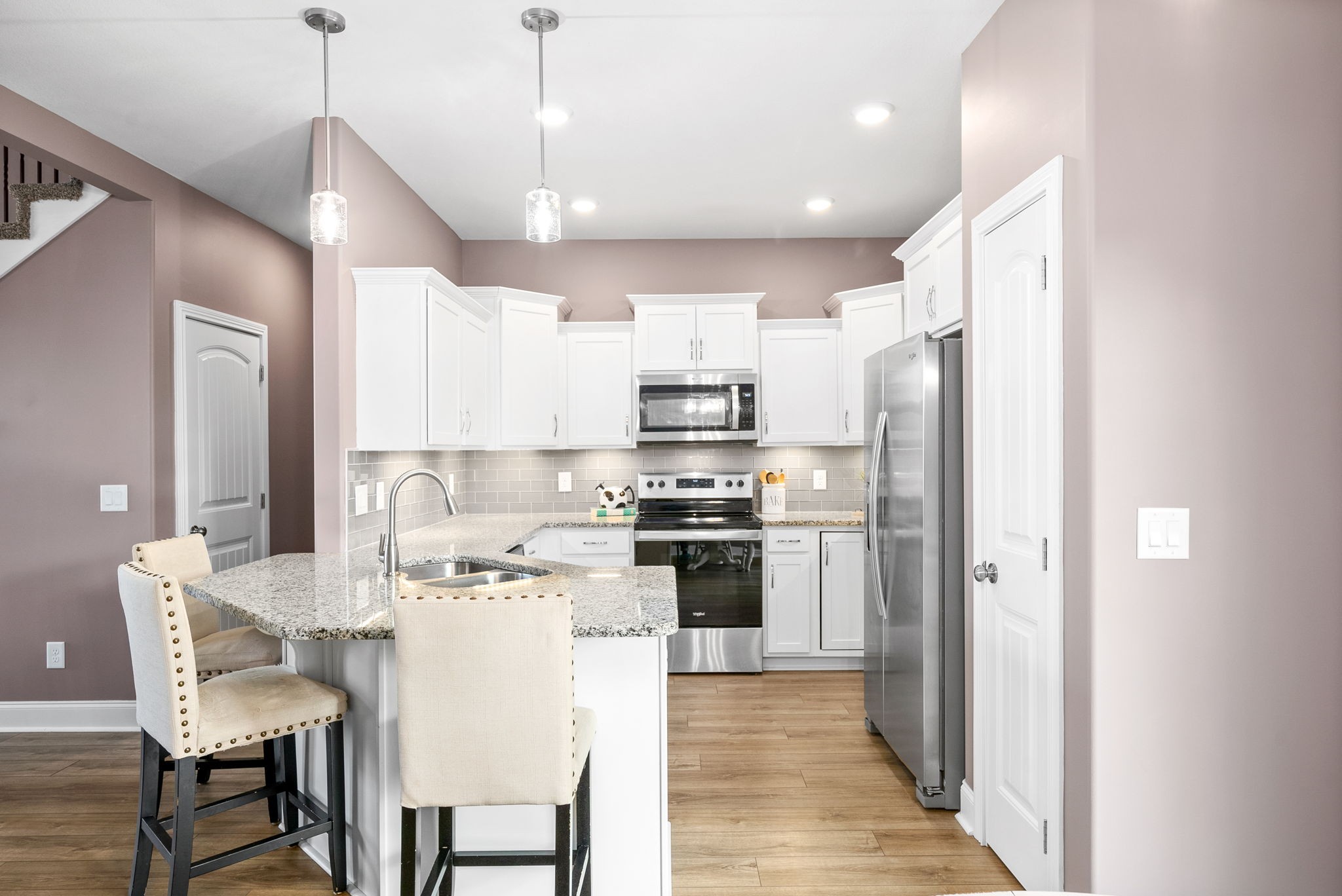 2251 Allen-Griffey Road Clarksville, TN 37042 - Photo 12 of 31 a kitchen with stainless steel appliances kitchen island granite countertop a refrigerator a stove a sink a dining table and chairs