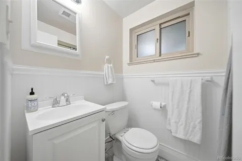 a bathroom with a sink toilet and a mirror