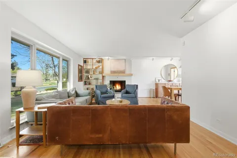 a living room with fireplace furniture and a window