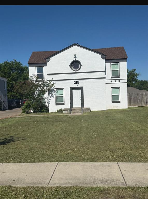 219 Southeast 13th Street, Unit 4 Grand Prairie, TX 75051 - Photo 1 of 5 a front view of a house with garden