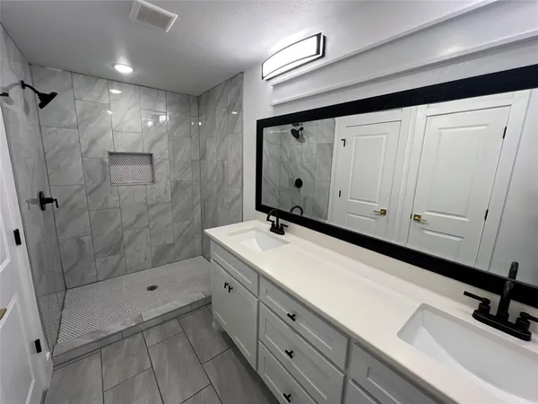 a bathroom with a sink and mirror