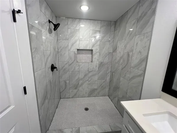 a bathroom with a bathtub and shower