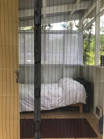 a bed sitting in a bedroom next to a window