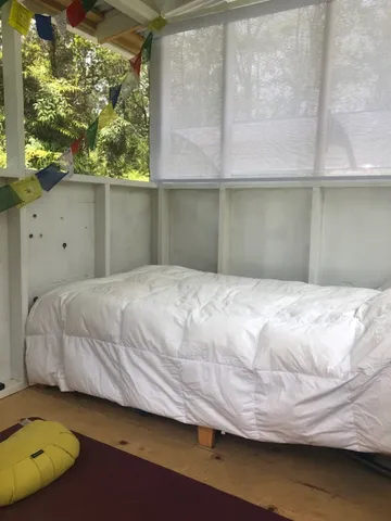 a bedroom with a bed and window