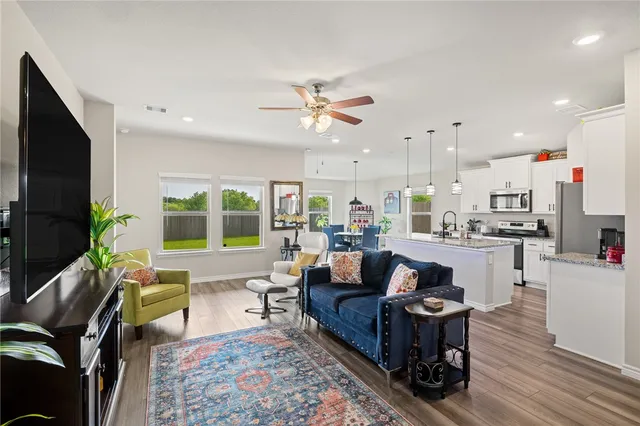 a kitchen with granite countertop a sink a refrigerator and a stove