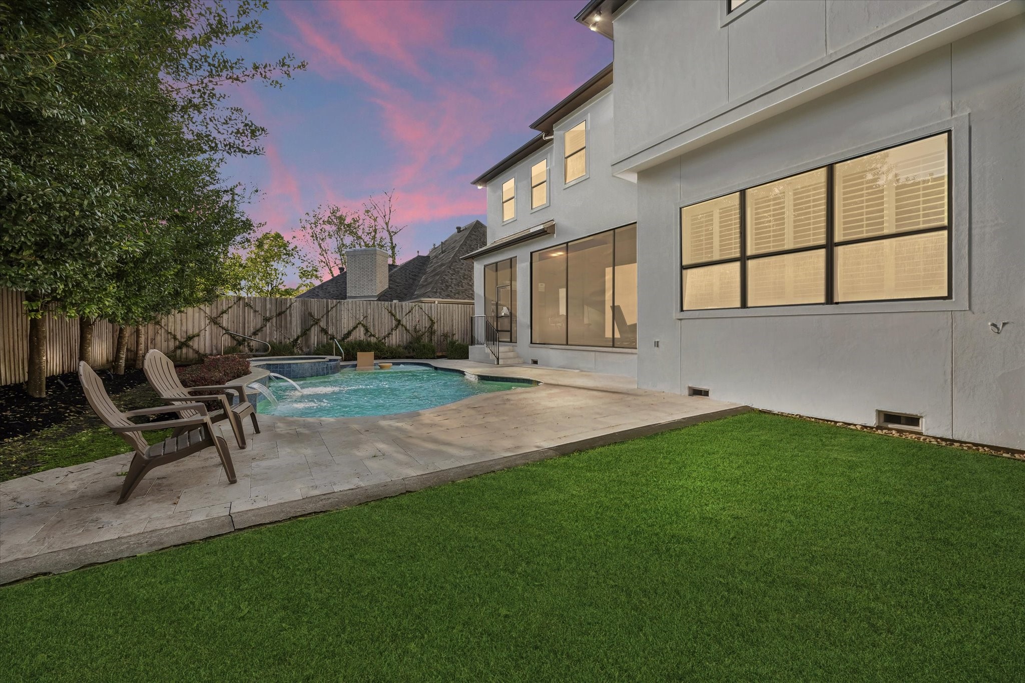 4511 Merrie Lane Bellaire, TX 77401 - Photo 2 of 46 a backyard of a house with table and chairs