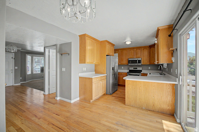 2058 California Avenue, Unit 2 Provo, UT 84606 - Photo 22 of 32 Kitchen featuring wood cabinetry, stainless steel appliances, and light-toned countertops