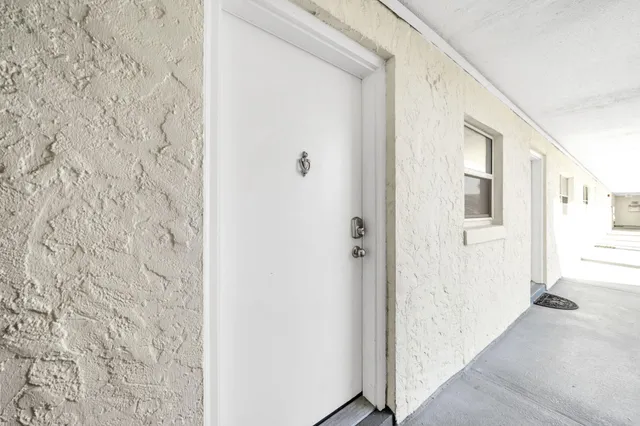 a living room with couches a dining table and a large window with garden view