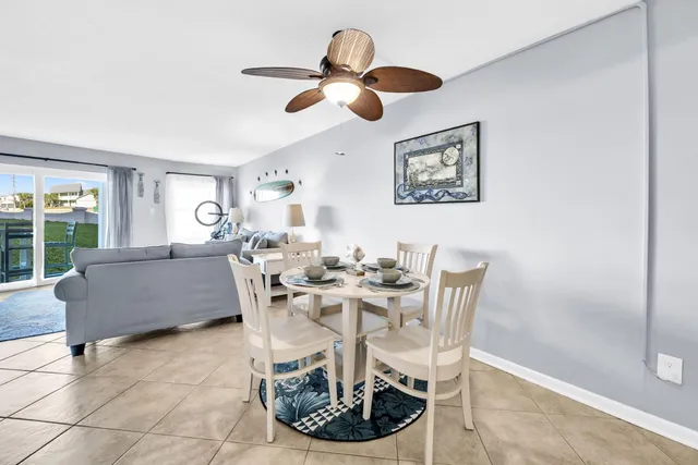 a view of a patio with a table chairs and a fire pit