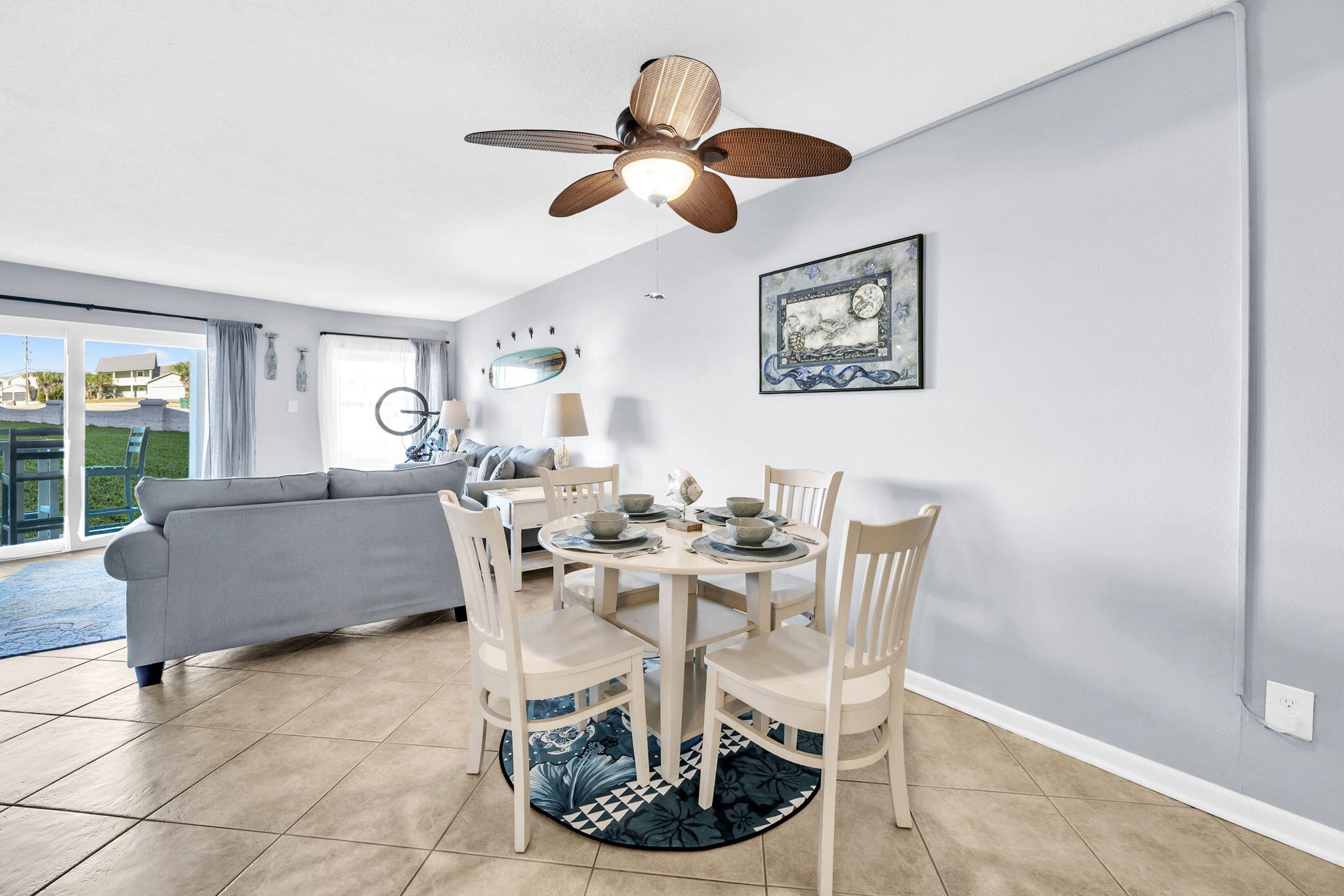 909 Santa Rosa Boulevard, Unit 515 Fort Walton Beach, FL 32548 - Photo 12 of 49 a living room with couches a dining table and a large window with garden view