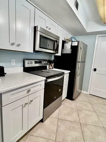 a kitchen with stainless steel appliances a stove sink and microwave