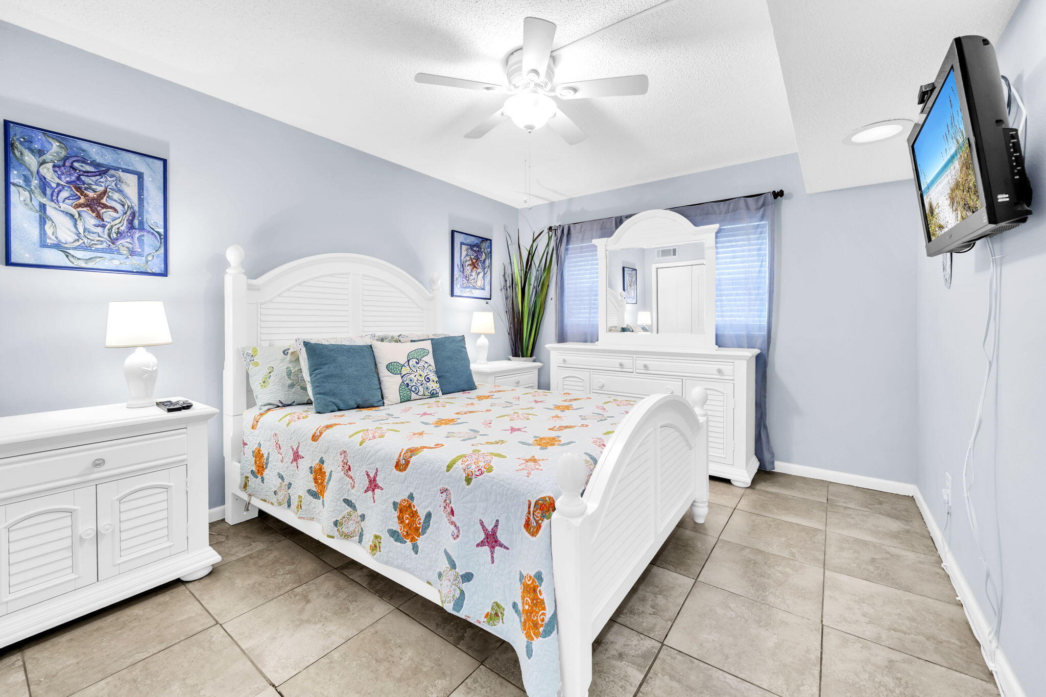 909 Santa Rosa Boulevard, Unit 515 Fort Walton Beach, FL 32548 - Photo 18 of 49 a bedroom with a large bed a flat tv screen and dresser