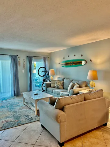 a living room with furniture and a lamp