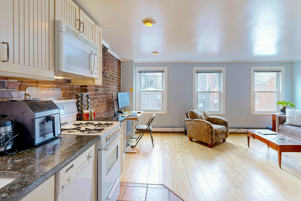 26 Unity Street, Unit 5 Boston, MA 02113 - Photo 3 of 15 a living room with furniture and a wooden floor