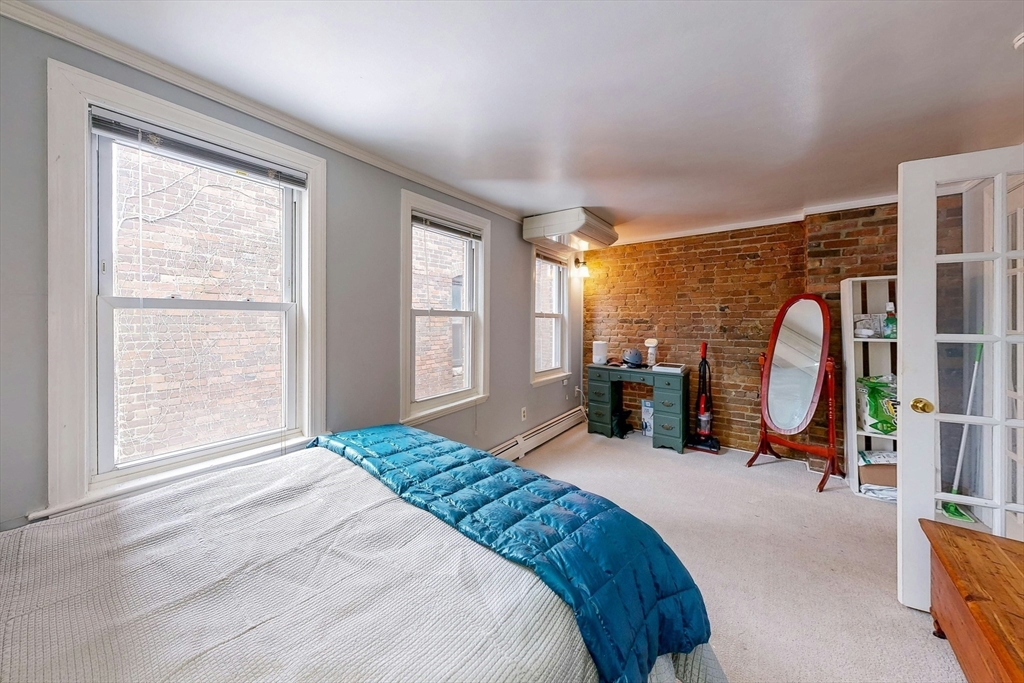 26 Unity Street, Unit 5 Boston, MA 02113 - Photo 9 of 15 a bedroom with bed and a large window