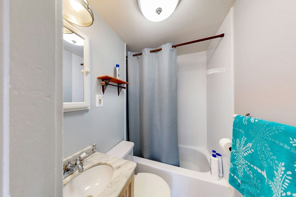26 Unity Street, Unit 5 Boston, MA 02113 - Photo 10 of 15 a bathroom with a sink and mirror with toilet