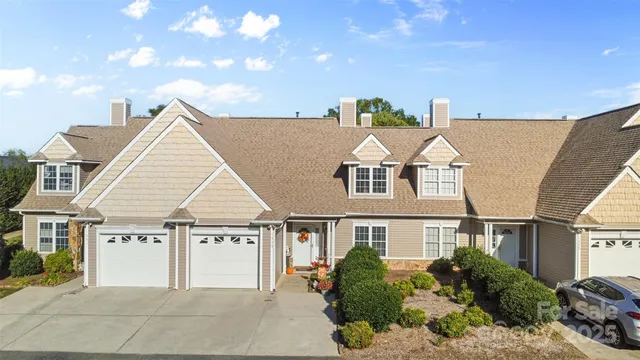 a view of a white house next to a yard