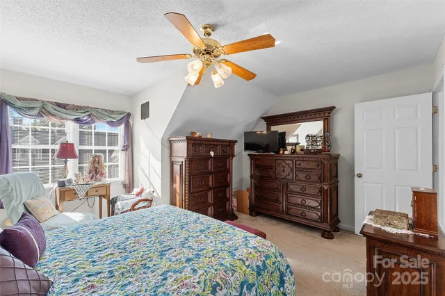 a bed room with a bed and a television