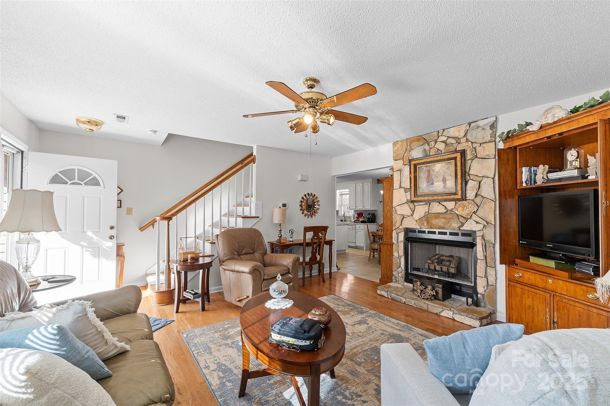 1553 16th Avenue Northeast, Unit 7 Hickory, NC 28601 - Photo 5 of 32 a living room with furniture a flat screen tv and a fireplace