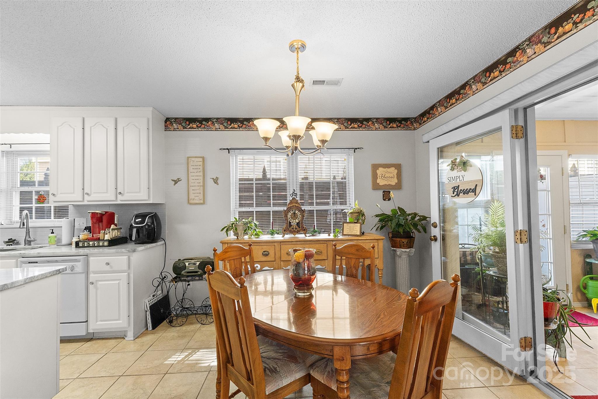 1553 16th Avenue Northeast, Unit 7 Hickory, NC 28601 - Photo 7 of 32 a dining room with furniture a chandelier and window