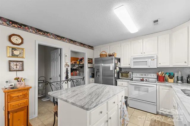 a kitchen with refrigerator cabinets and wooden floor