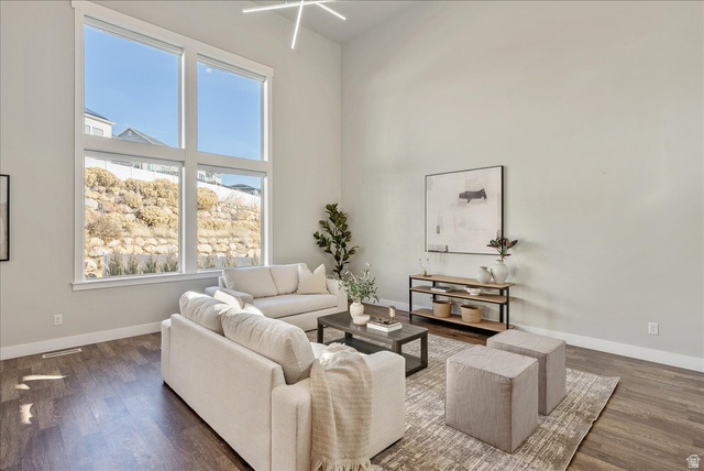 882 Spring Dew Lane Lehi, UT 84048 - Photo 26 of 46 Living area with dark wood-type flooring and a high ceiling