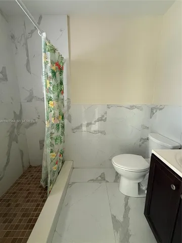 a bathroom with a toilet and shower