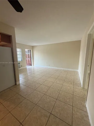 a view of wooden floor and windows in a room