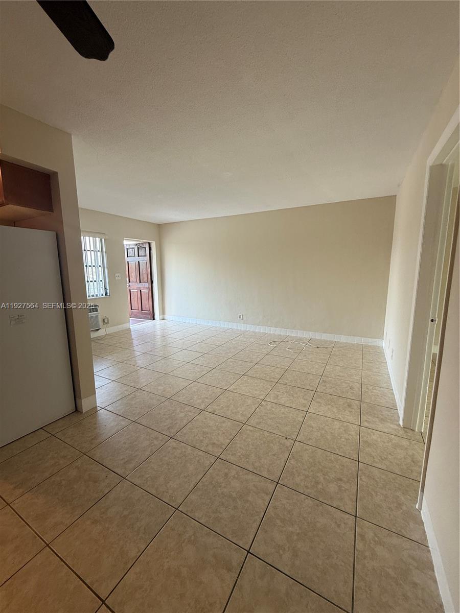 1211 Northeast 23rd Avenue, Unit 5 Pompano Beach, FL 33062 - Photo 5 of 10 a view of wooden floor and windows in a room