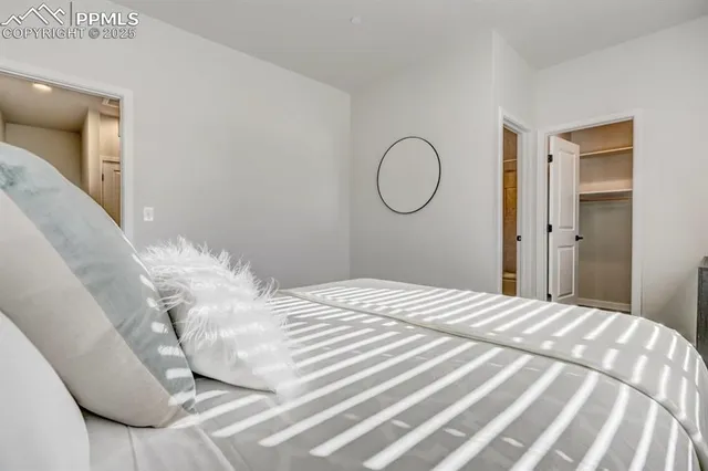 a bedroom with a bed and a mirror